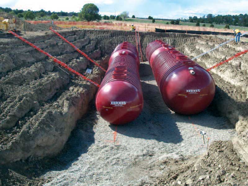 Fiberglass treatment tanks being set